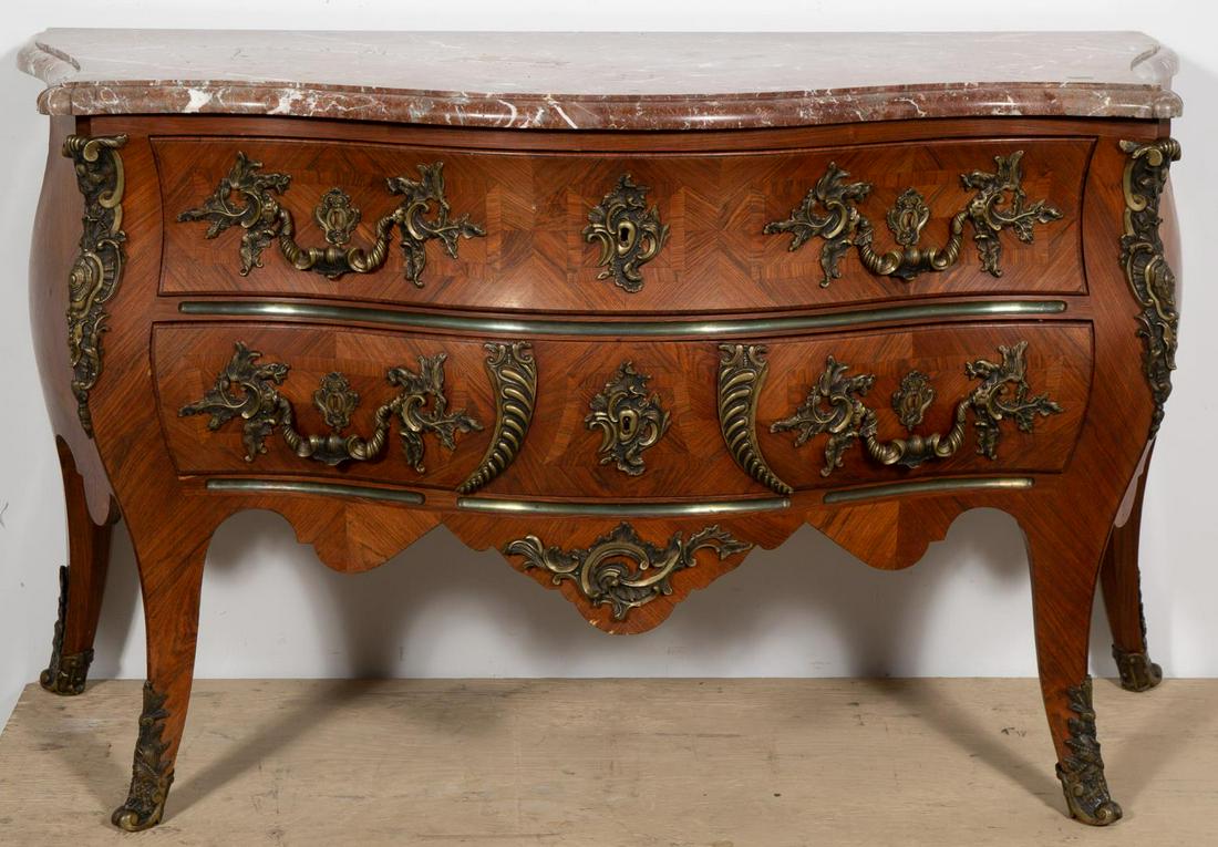 19th C., Signed Continental Marble Top Commode: Continental, late 19th to early 20th century. Wooden marquetry inlaid two drawer chest having a swelled form with conforming brown marble top, bronze mounts and rising on cariole legs with sabots. Sta