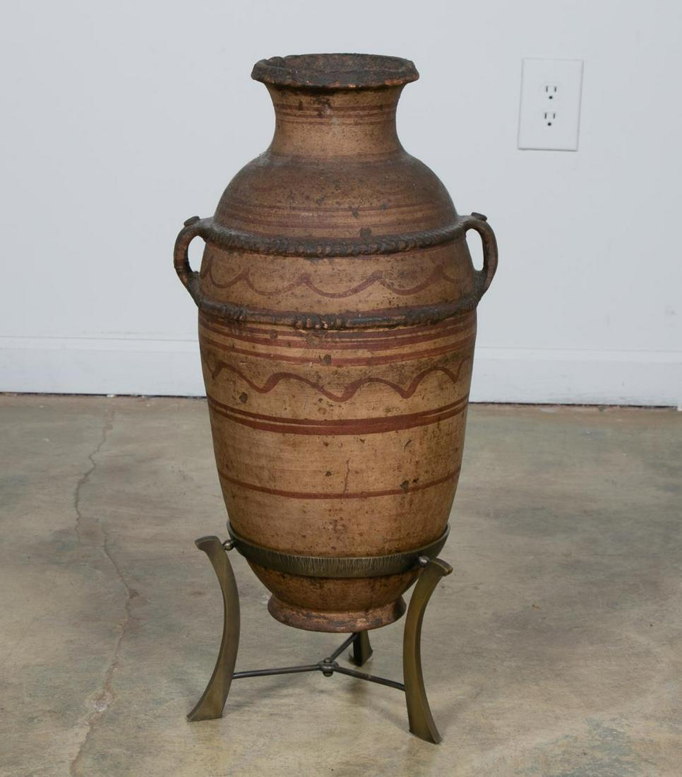 Early Terra Cotta Storage Jar With Custom Base: Continental, 19th century or earlier. Terra cotta amphora form vessel having applied double handles, ocher color decoration and a custom bronze base. Unmarked. Approx. h. 26.5", dia. of mouth 6".