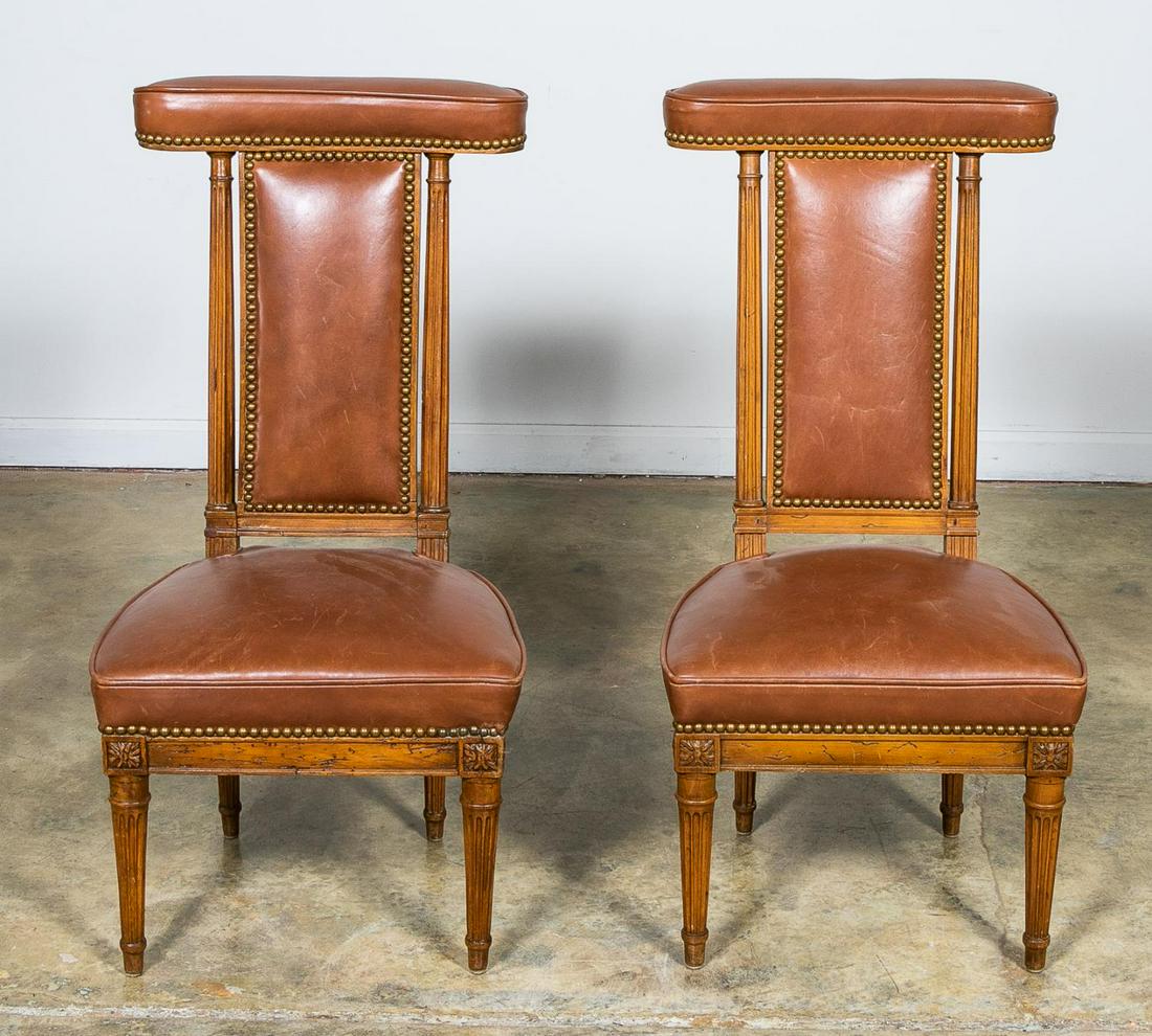 Pr., French Louis XVI Style Prie Dieu Chairs: French, 19th century. Pair, walnut framed prie dieu chairs having brown leather upholstery with brass nail heads, fluted stiles and rising on fluted tapered legs. Unmarked. Approx. h. 35", d, 17.75", 
