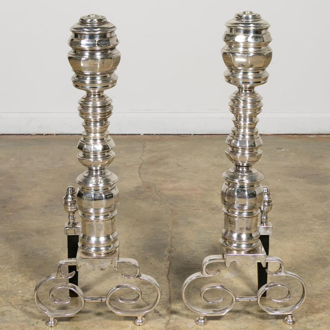 Pair English Silver Plated Georgian Style Andirons: English, early 20th century. Pair of silver plated Georgian style andirons of baluster form set on scrolled legs and bell shaped feet. Apparently unmarked. Approx: h. 27", d. 10.75".