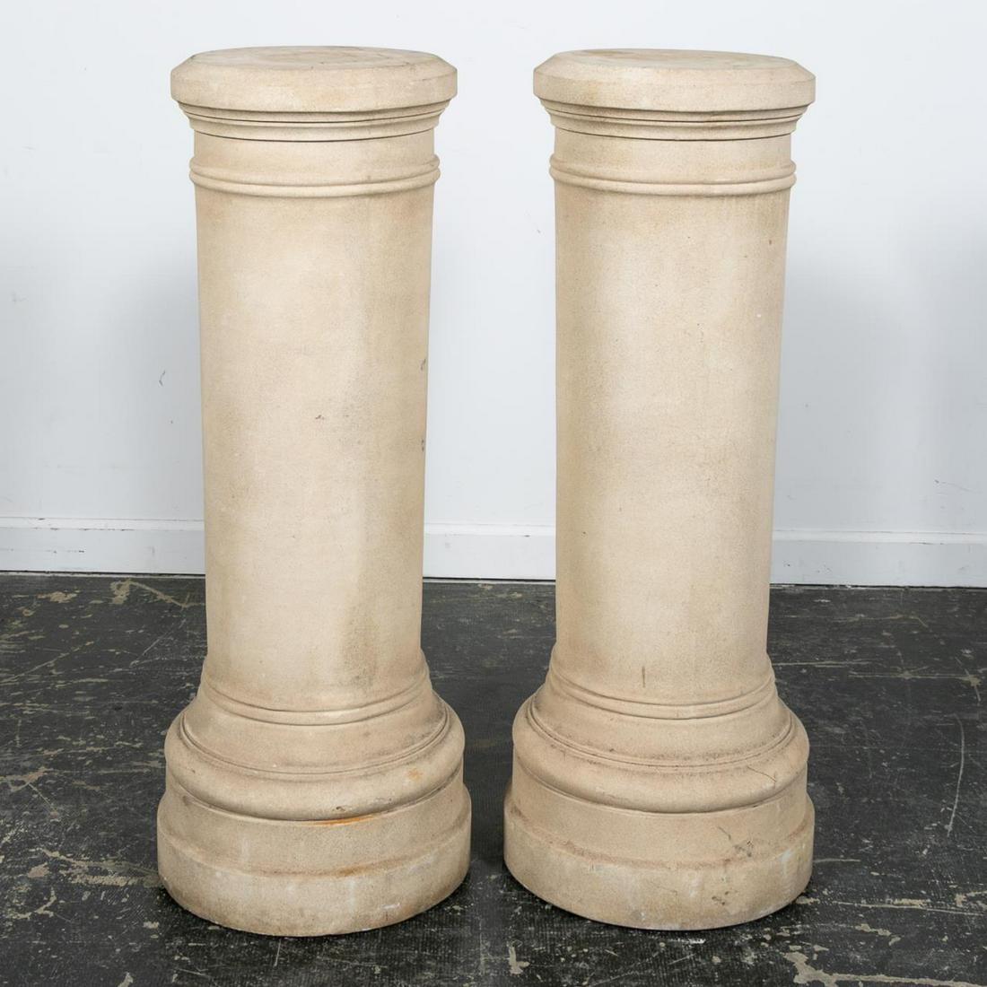Pair, Michael Taylor Cast Stone Columns: Michael Taylor Designs, Inc. (American, founded 1985). Pair of unadorned cast stone circular columns or pedestals having a ringed body band rising on a conforming plinth. Unmarked. Approx. of one h. 4