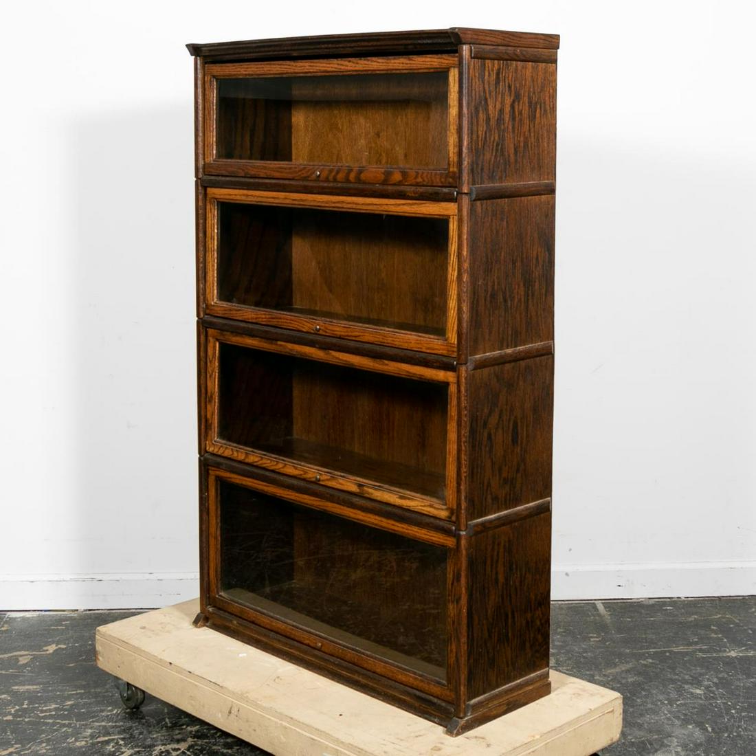 E. 20th Century Oak Barrister Bookcase, Four-Tier: American or English, early 20th century. A Globe Wernicke style Oak Barrister bookcase with swinging glass doors and four shelves. Unmarked. Approx. h. 58", w. 36.25", d. 13".