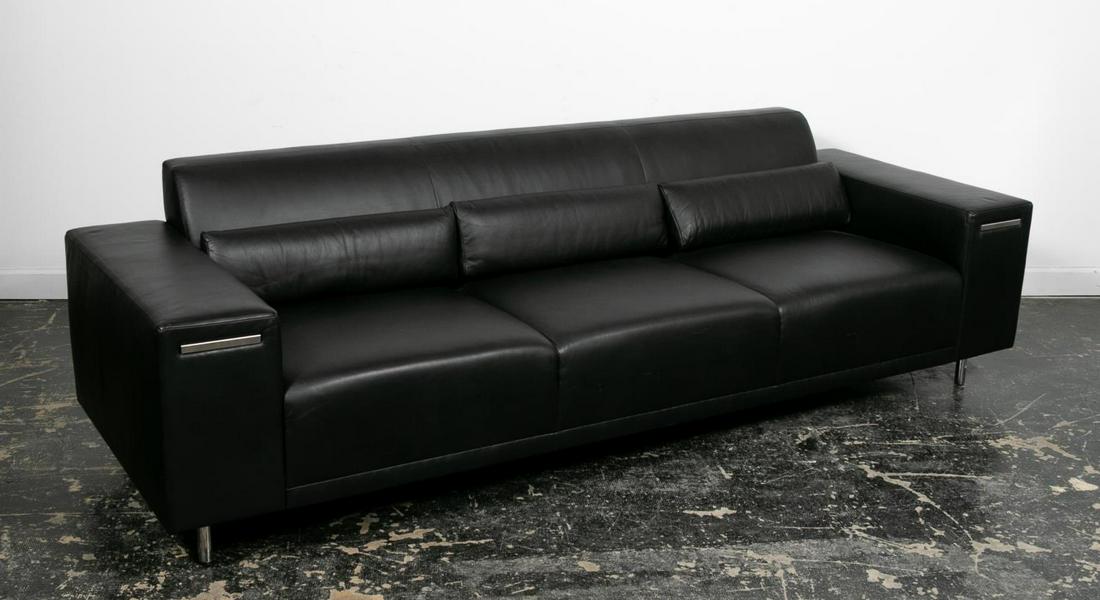 Brueton "American" 3 Seat Leather Upholstered Sofa: Stanley Jay Friedman for Brueton Furniture (American, est. 20th century), 21st century. A contemporary clean from "American" three seat sofa with aluminum covered pull out tablets located in arms. App