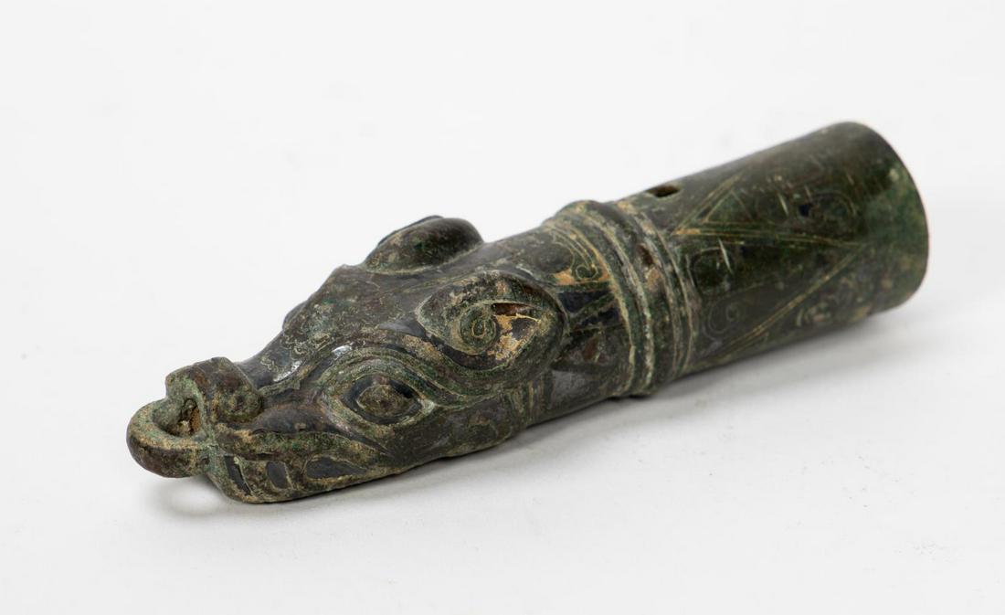 Han Dynasty Gilt Bronze Buffalo Chariot Fitting: Chinese, Han Dynasty, the chariot fitting with stylized buffalo head having a ring at one end and curled horns, the open end with incised lappets and an encircled ring band, with some gilt decoration 