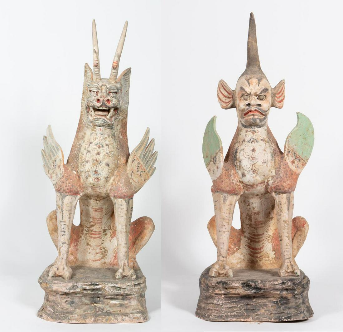 Two Chinese Han Dynasty Earthenware Earth Spirits: Chinese, Han Dynasty. A painted earthenware semi-human earth spirit with a single horn protruded from the top of its head, and having shoulders with flame form wings, with the legs ending in cloven ho