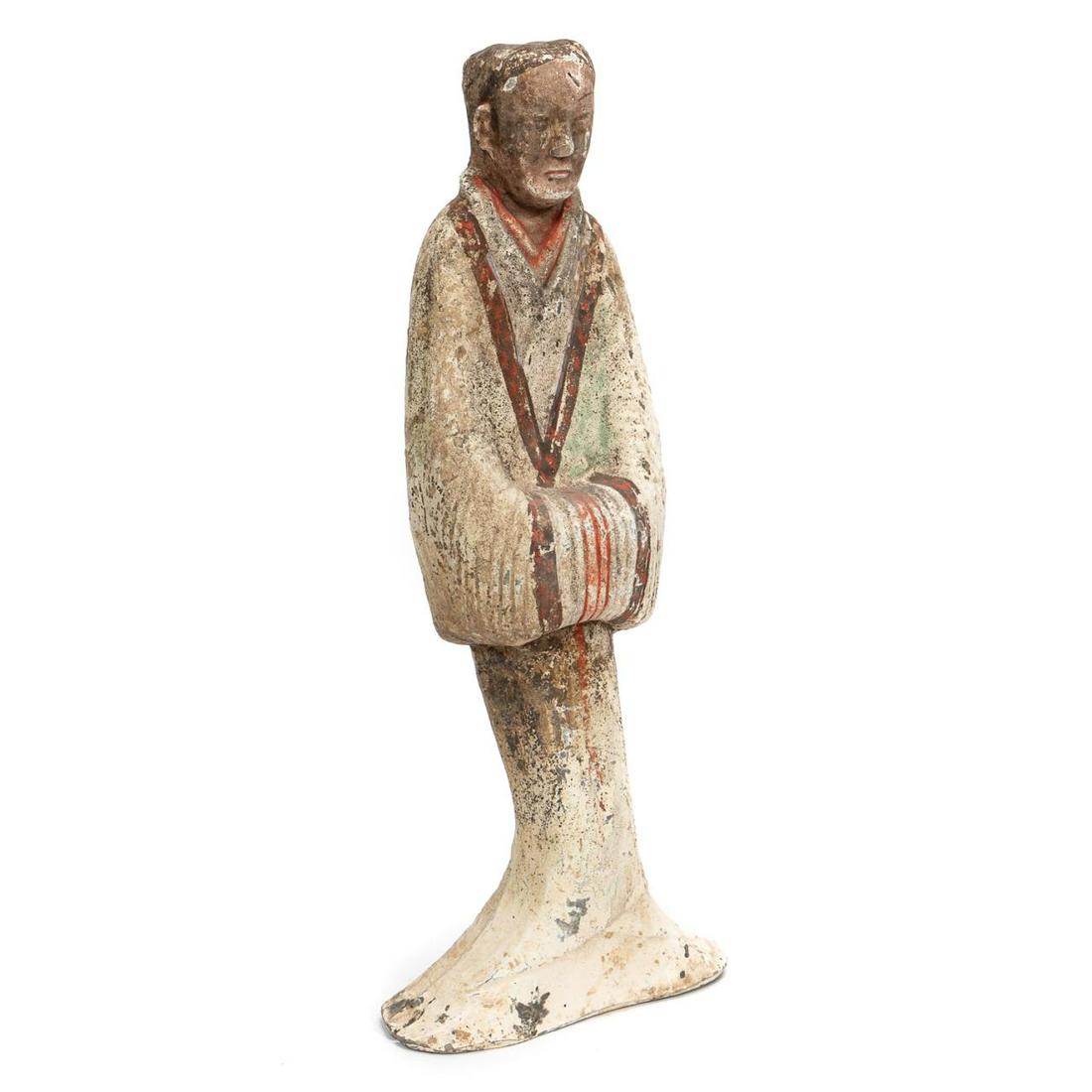 Western Han Dynasty Painted Standing Court Figure: Chinese, Han Dynasty. The painted pottery male figure with flowing robes, hands held together and hidden in the robe sleeves. The robe flowing onto the ground. Painted in red, brown and flesh colored 
