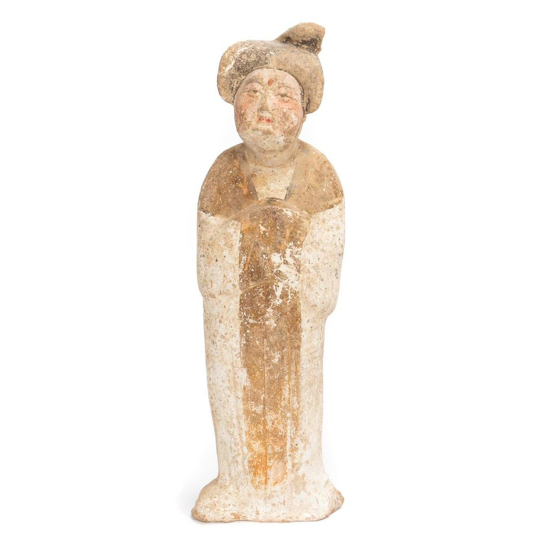 Chinese Han Dynasty Painted Pottery Figure: Chinese, Han dynasty. The painted pottery figure in a robe, hands held together and hidden in the robe sleeves. Painted in brown, white, and flesh colored pigments. Approx: h. 11.5" w. 3.25" d. 2.5". 