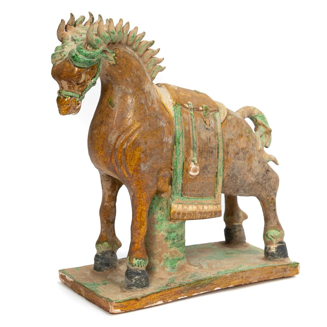 Chinese Ming Dynasty Glazed Ceramic Horse: Chinese, Ming Dynasty. The Ming horse standing foursquare with a support post joining the rectangular base with the horse's chest. Flowing mane swept back over the ears continuing as two comma form ro