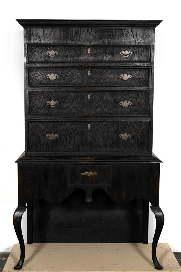 Bobby McAlpine "Great Scott’" Ebonized Oak Highboy: Bobby McAlpine (American, 20th century), 21st century. British crafted ebonized oak highboy in the Queen Anne taste having a shaped cornice and hinged top with concealed storage, four graduated drawer