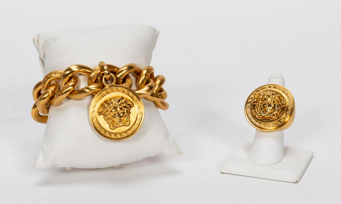 Versace "Medusa" Logo Bracelet & Ring Set: Gianni Versace Fashion (Italian, founded 1978). A two-piece set of "Medusa" logo jewelry including a bracelet with hanging medallion and a large faced ring. Marked "Versace, Made in Italy" to each. Ap