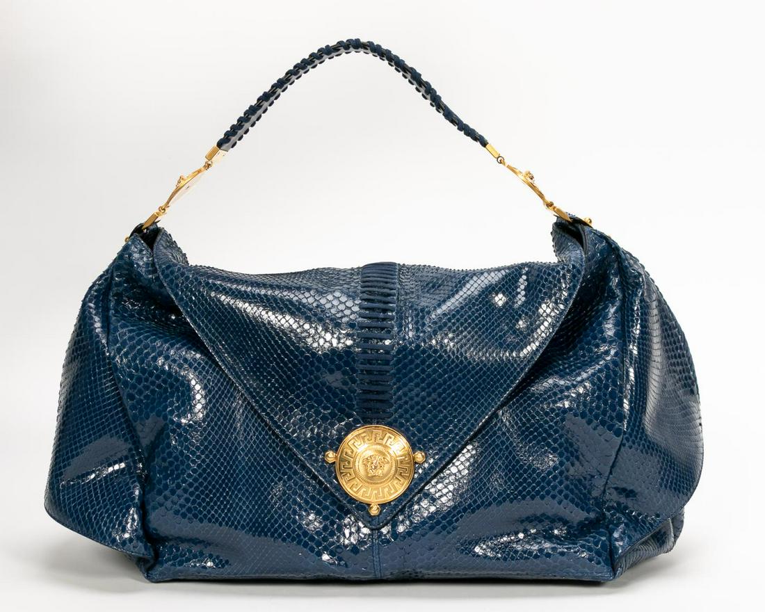 Versace Blue Python & Suede "Medusa" Handbag: Gianni Versace Fashion (Italian, founded 1978). A blue python handbag with gold tone "Medusa" hardware, single flap closure and a suede lined interior featuring two interior open pockets and a large s
