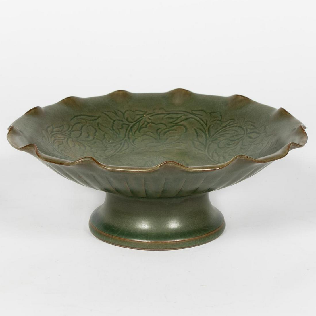 Chinese Qing Celadon Earthenware Compote: Chinese, Qing dynasty. Dark green celadon glazed earthenware compote with pedestal base and ruffled rim, incised bowl decoration of a flowering vine. Unmarked. Approx. h. 3.625", dia. 9.625"