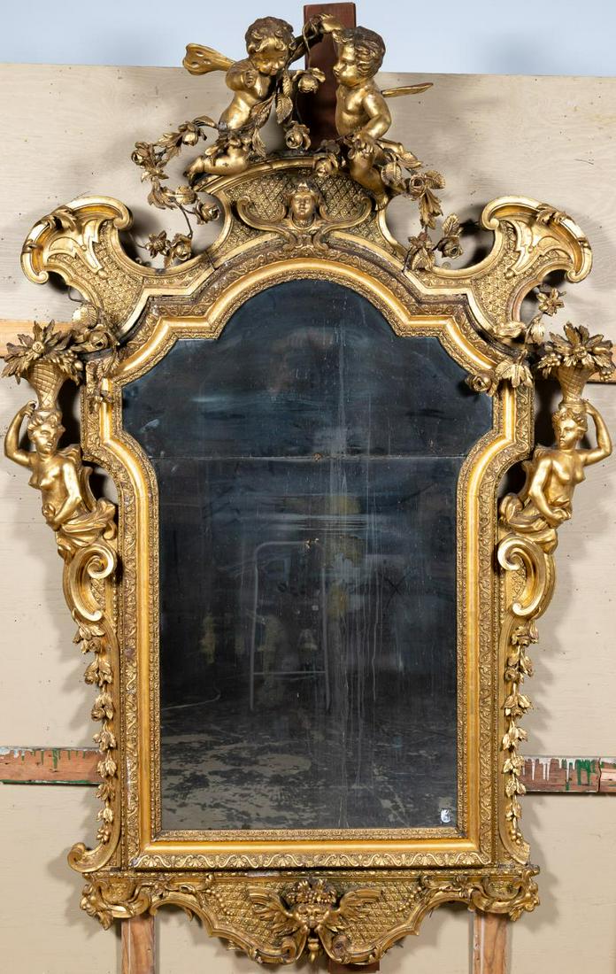 Palatial Louis XV Gilt Wood Putti Crest Mirror: French, late 19th century. Palatial size Louis XV rococo style gilt wood & gesso framed mirror with crest of flying putti holding rose garlands, the frame sides with demi-figures of draped female nude