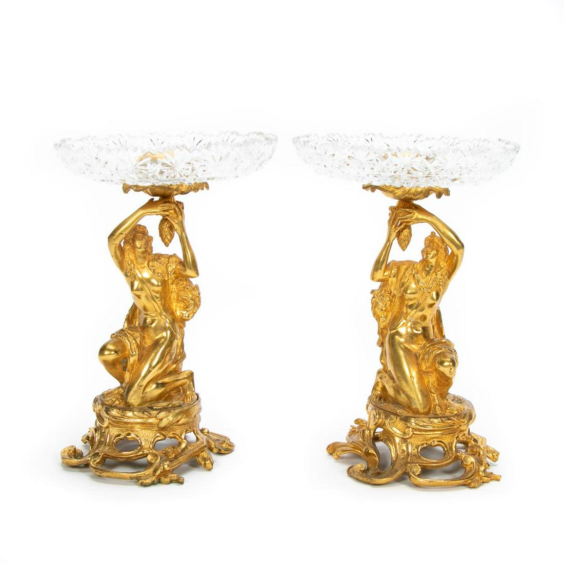 Pair, French Gilt Figural Bronze & Glass Tazzas: French, late 19th century. Pair of gilded bronze and cut glass tazzas in the rococo taste having scalloped cut glass or crystal bowls supported by figural maidens with musical instruments, on a scroll