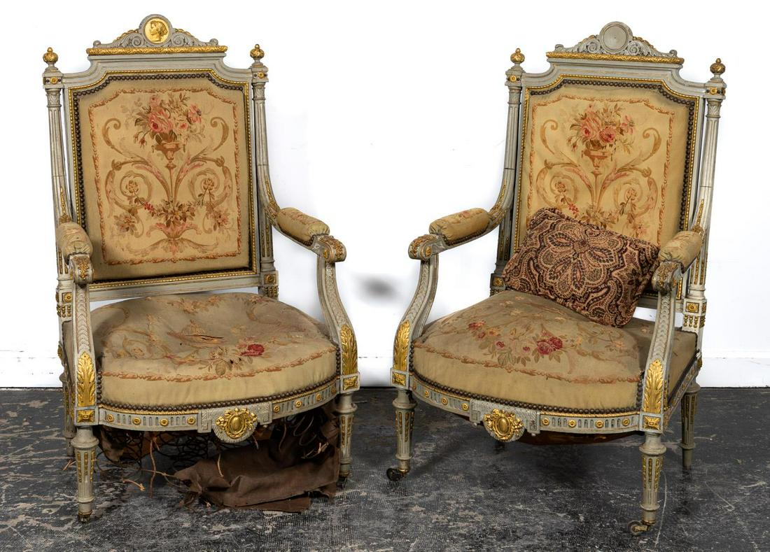 Pr., Louis XVI Style Painted Parcel Gilt Fauteuils: Likely French, late 19th to early 20th century. Pair of Louis XVI style painted wooden parcel-gilt ormolu mounted fauteuils a la reine or armchairs having squared backs with scrolled crest decorated w
