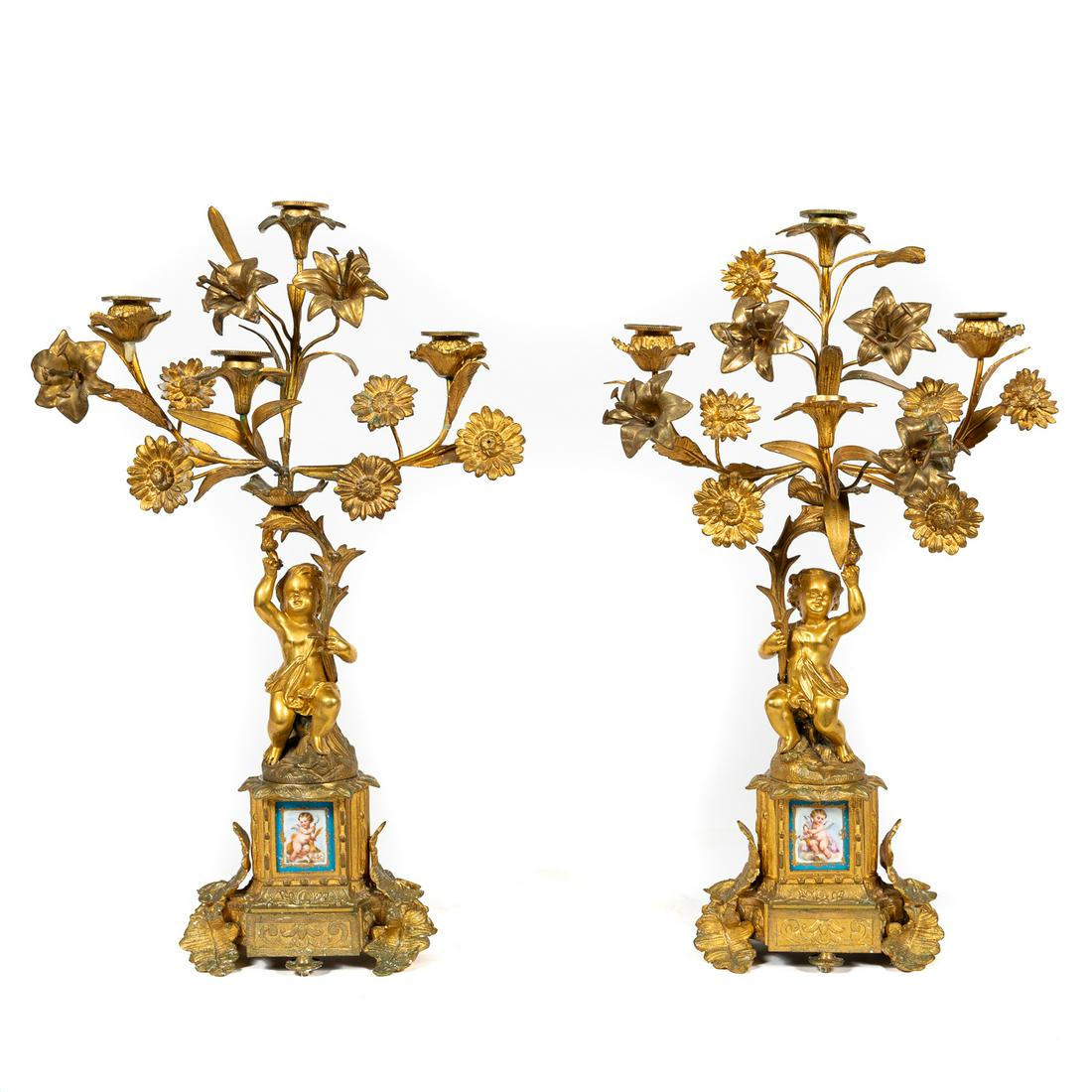 Pair, Louis XV Style Gilt Bronze Putti Candelabrum: French, late 19th century. Pair of rococo Louis XV style 4-light floral branch and figural stem mantel candelabrum with inset Sevres-type porcelain allegorical plaques of putti depicting spring and fa