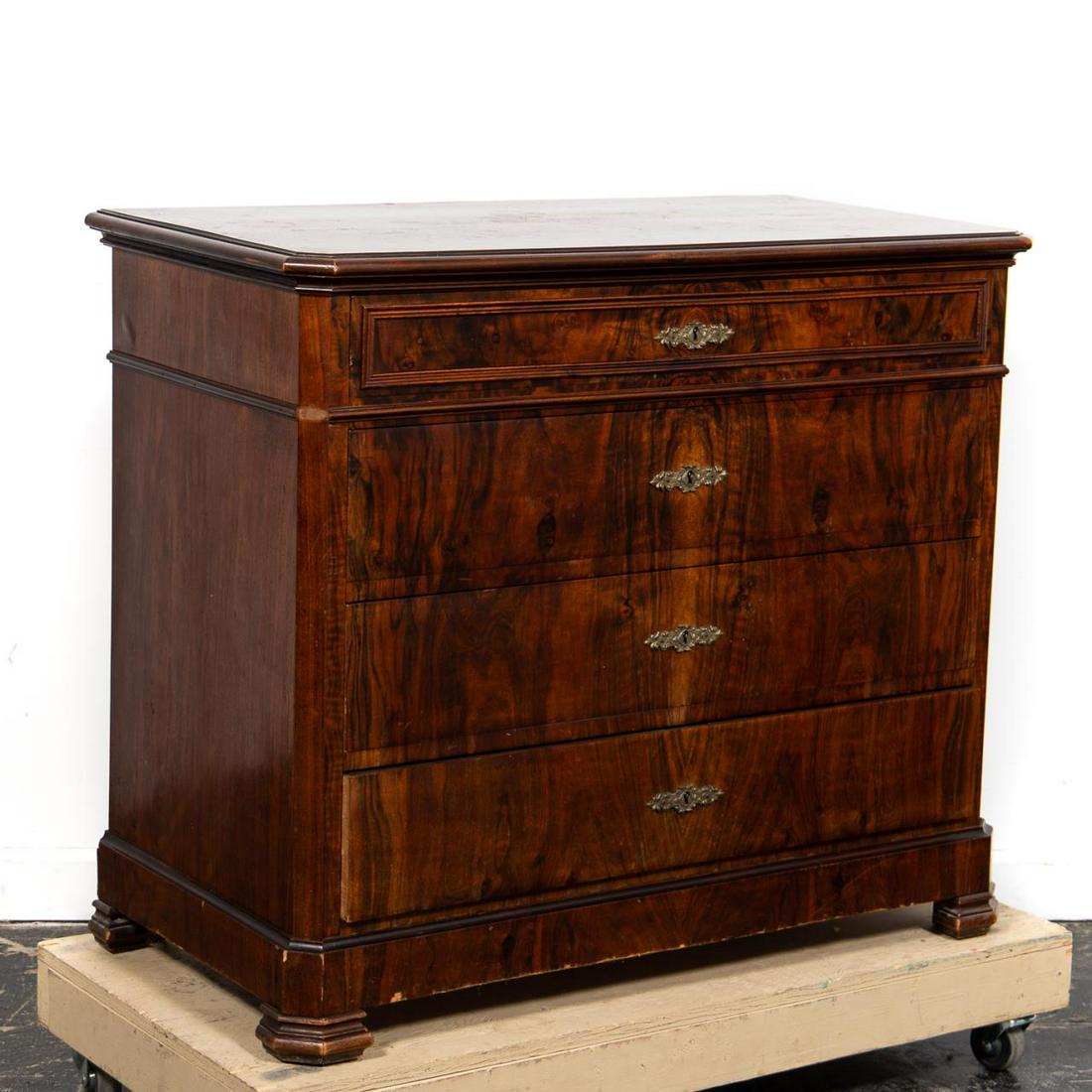19th C. Louis Philippe Style Walnut Commode: Continental, 19th century. Highly figured walnut veneered commode or chest in the Louis Philippe taste having an overhanging top, four-drawers and rising on bracket feet. Unmarked. Approx: h. 37", w. 
