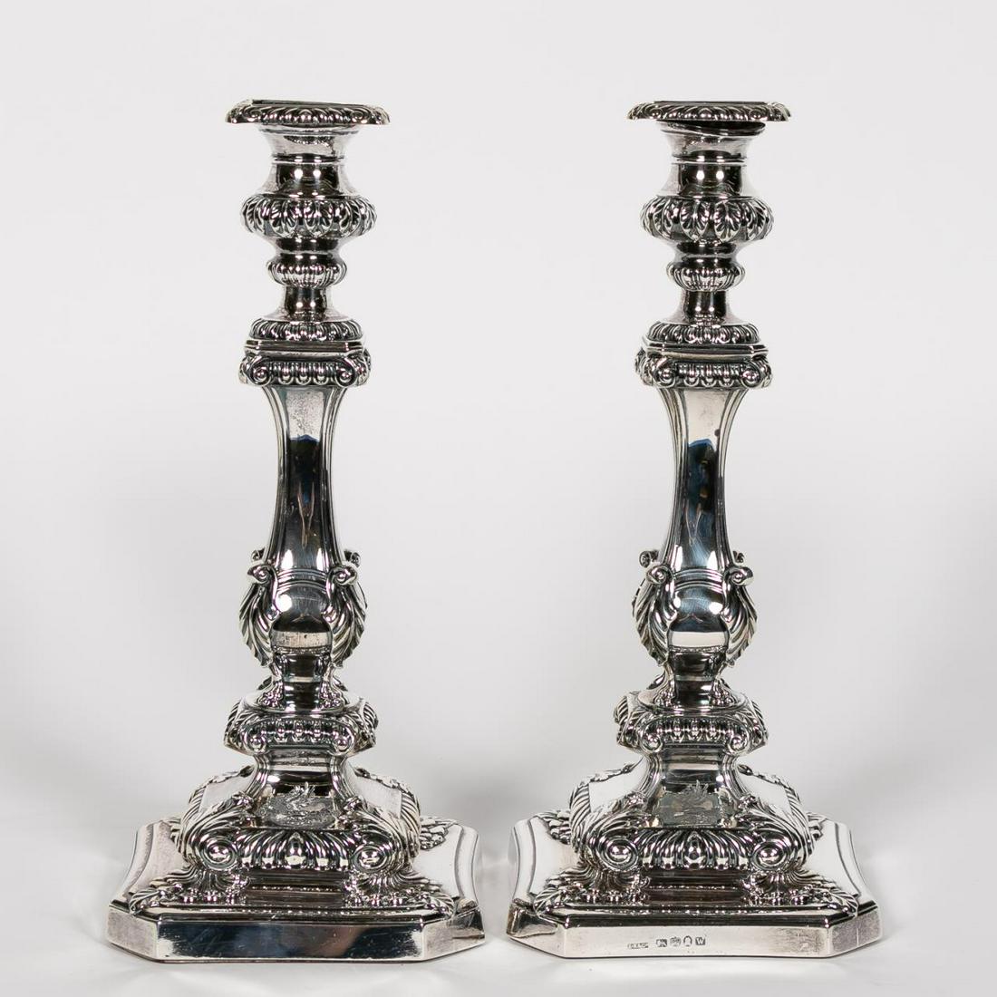 Pair, George III Sterling Silver Candlesticks: John Roberts & Co (English, 1805-1820). A pair sterling silver candlesticks with removable drip pans, weighted mahogany planked base and a pegasus armorial crest to the base of each. Hallmarked "I.R. 