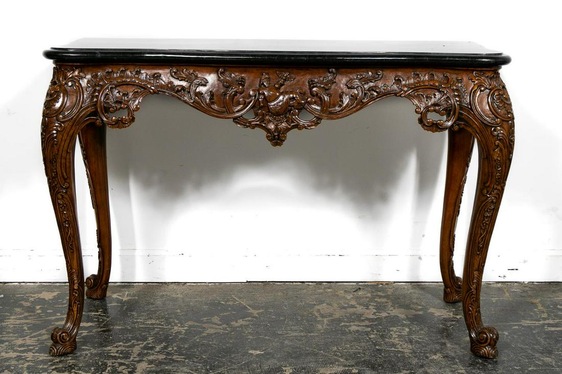 Maitland Smith Rococo Chinoiserie Style Console: Maitland Smith (American, founded 1979). Carved wooden console table in the rococo taste having a shaped tessellated stone top, serpentine apron with scrolled decoration and a chinoiserie figure, risi