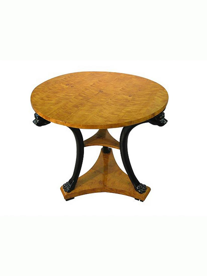 19th Century, Biedermeier Maple Center Table: Continental, 19th century. A Biedermeier maple veneered round center table with black arching dog motif legs with paw feet. Approx. h. 32.5", diameter of top 35.5"