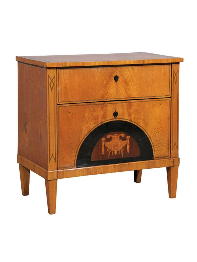 19th C. Biedermeier Inlaid Two Drawer Commode: German, circa 1820. Two-drawer Biedermeier fruitwood commode or chest having an overhanging top, draped figural inlay to the lower drawer and rising on tapered feet. Unmarked. Approx. h. 30.75", w. 31