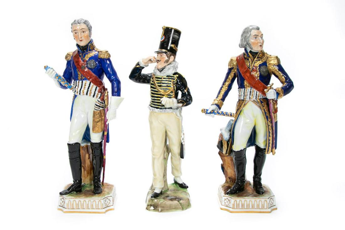 Three, Dresden Porcelain Military Figurines: Dresden Porcelain (German, founded 1872). Three porcelain military figurines including the officer of the 11th Hussars (h. 11"), A Carl Thieme Dresden Napoleon Marshall figure signed "Massena" to back