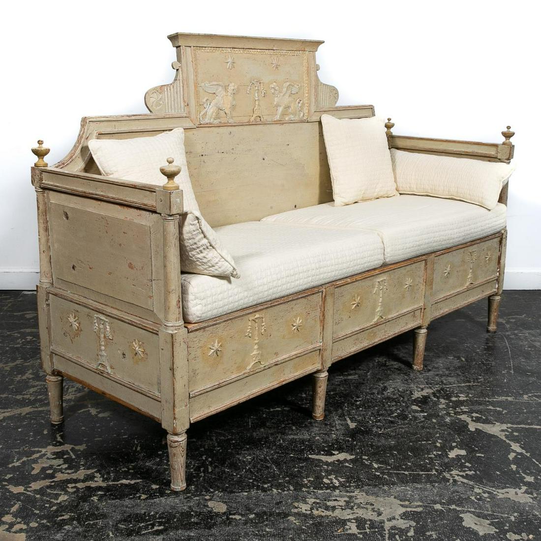 19th C. Gustavian Swedish Painted Wooden Bench: Swedish, early 19th century. Painted wooden Gustavian bench having a pleasing distressed/stripped finish decorated with griffins, oil lamps and stars, the paneled sides with turned finials and fully e