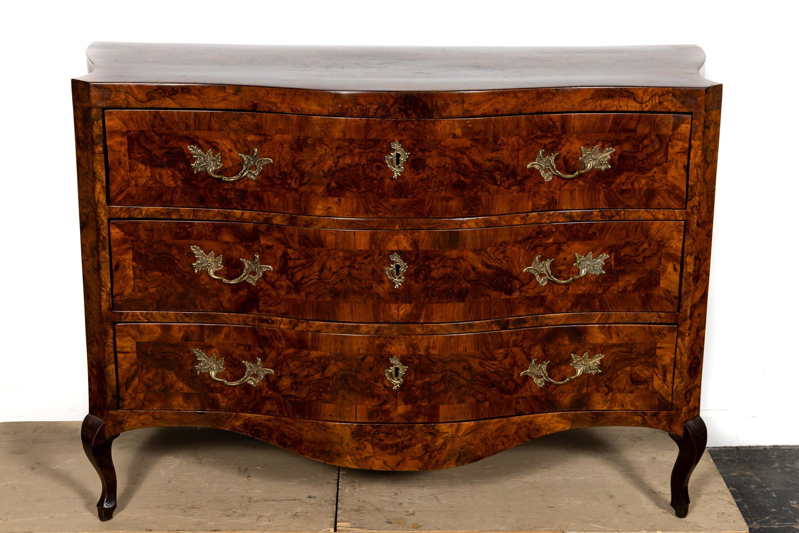 18th C. Italian Rococo Burl Walnut Commode: Italian, 18th century. Serpentine form rococo burl walnut veneered commode of chest having a vivid grain, and rising on front cabriolet legs. Unmarked. Approx. h. 38.5", w. 57", d. 25.5".
