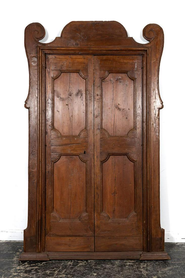 18th C. Italian Baroque Doors With Original Frame: Italian, 18th century. Pair of carved architectural baroque pine doors having a scrolled pediment frame containing double ovolo paneled doors. Unmarked. Approx. h. 85", w. 54". Provenance: From The Es
