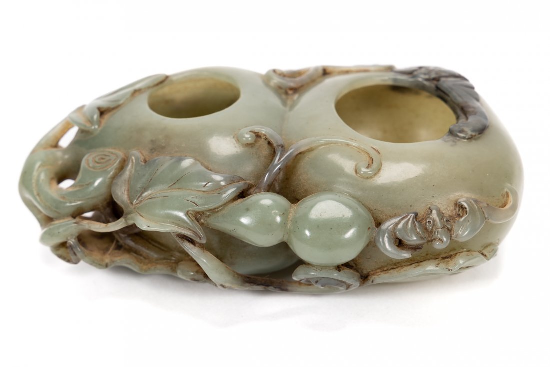 CHINESE CELADON JADE CARVED GOURD FORM INKWELL: Chinese. A celadon jade double inkwell, carved with foliate leaves, floral blossom shape and two bats to the lower edge. Apparently unmarked. Approx. h. 1.75", w. 3.5", d. 5.25".