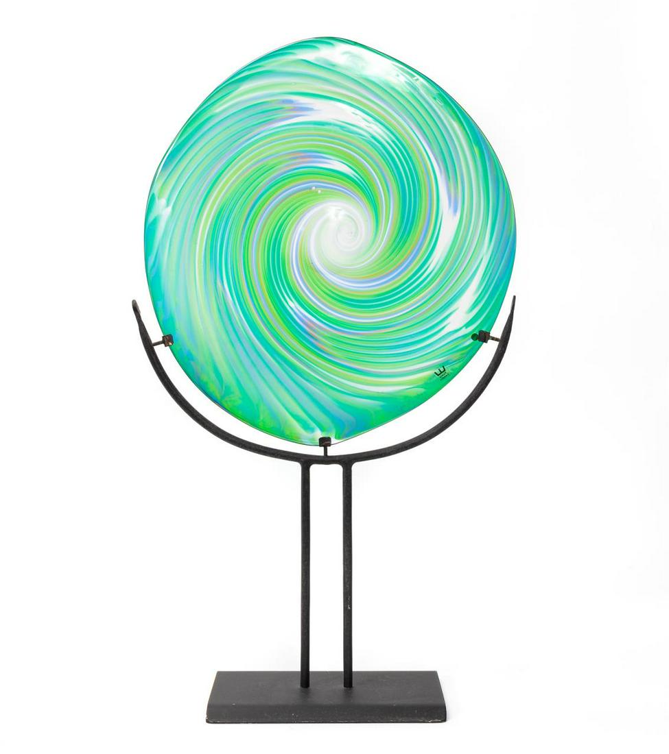 ANN & GORAN WARFF FOR KOSTA BODA, ART GLASS DISC: Ann Warff (Swedish / German, born 1937), Goran Warff (Swedish, born 1933) for Kosta Boda or Kosta Glasbruk (Swedish, 1742). An art glass disc sculpture with green, blue and purple coloring, polished p