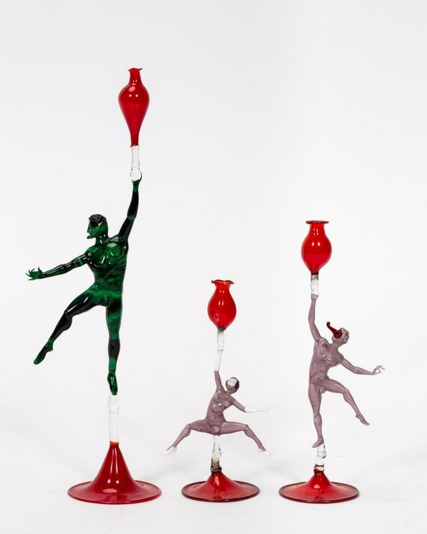 GROUP, LUCIO BUBACCO "EROTIC DANCERS" GLASS VESSEL: Lucio Bubacco (Italian, born 1957), 20th century. A group of three Murano erotic dancer stemmed liquor vessels including a male and female with purple bodies and a larger male with malachite textured