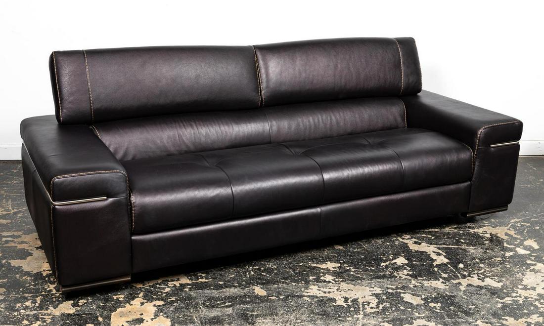 NATUZZI ITALIA "AVAN" CONTEMPORARY LEATHER SOFA: Natuzzi Italia (Italy, founded 1959), 21st century. A dark brown leather "Avana" - V570 three seater sofa with metal accents, and adjustable headrests. Marked to right side. Approx. h. 27" (head rest