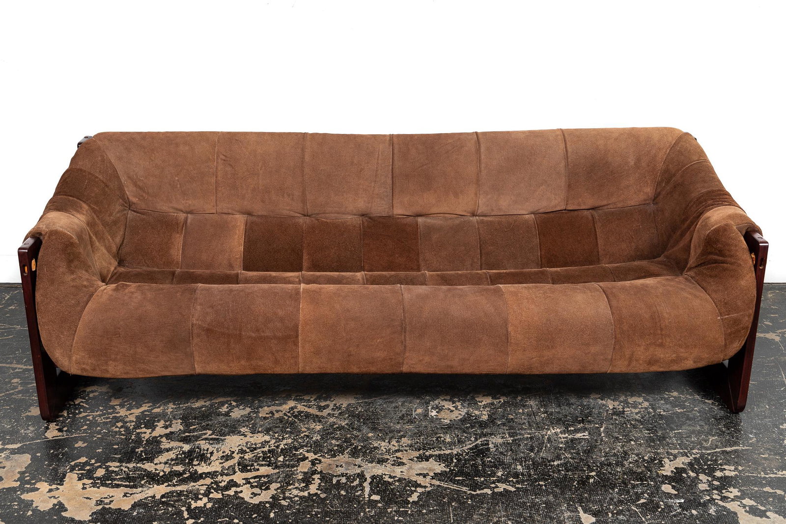 PERCIVAL LAFER MID-CENTURY MODERN SUEDE SOFA: Percival Lafer (Brazilian, 20th century), c.1965. A Mid-Century Modern Brazilian rosewood and tufted suede sofa having a pre-formed seat, arm, and back cushion. Silver makers mark sticker to front lef