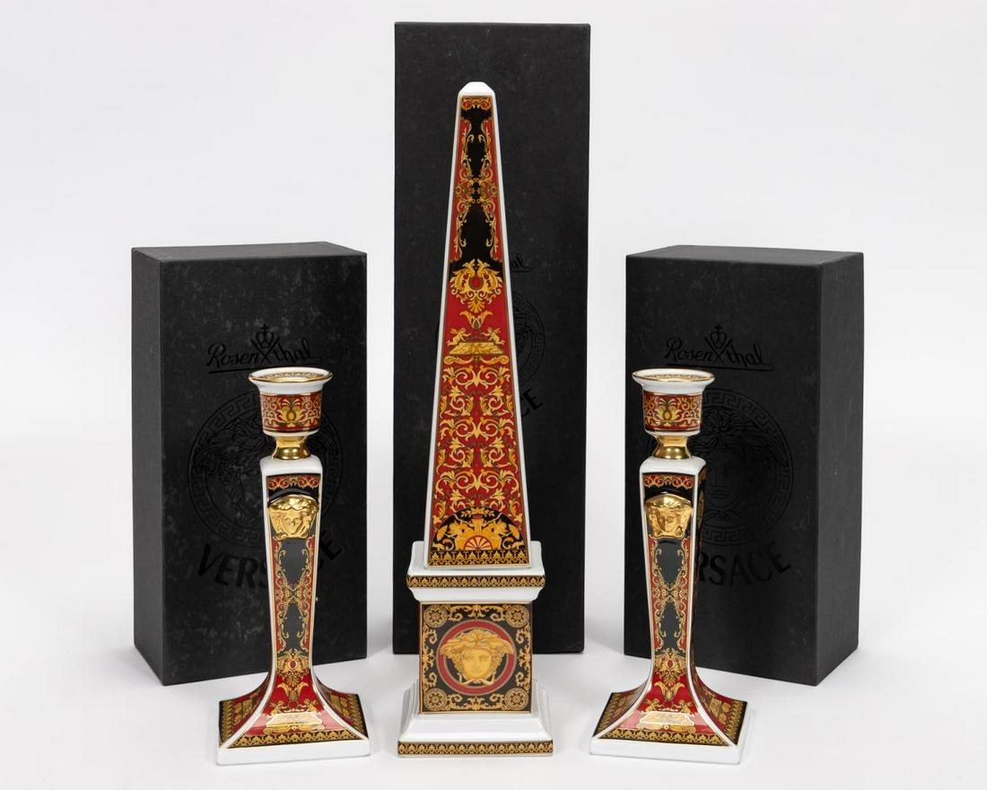 VERSACE ROSENTHAL, OBELISK & CANDLESTICKS: Versace (Italian, founded 1978), Rosenthal (German, founded 1879), late 20th century. Three piece group of Versace Meets Rosenthal gilded "Ikarus Medusa" or "Medusa" (introduced 1994) porcelain compri