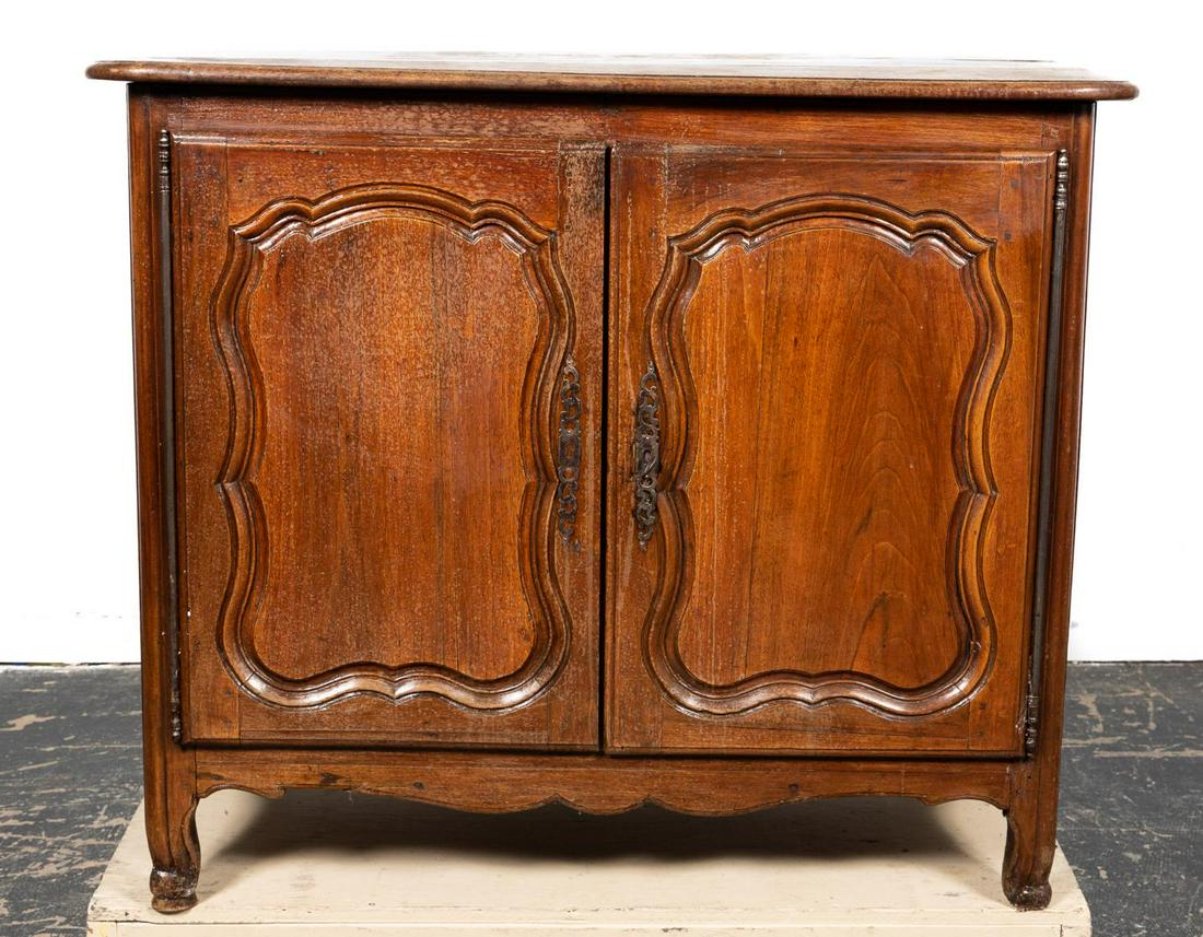 FRENCH LOUIS XV WALNUT TWO-DOOR BUFFET, 18TH C.: French, 18th century. Louis XV walnut buffet having an overhanging top, double paneled doors, interior fitted with a shelf and rising on slight cabriole legs. Unmarked. Approx. h. 39.5", w. 47.5", d. 