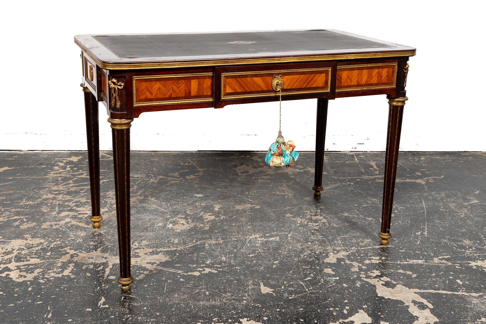 E. 20TH C. FRENCH NEOCLASSICAL STYLE CONSOLE: French, early 20th century. Parquetry inlaid small console table or ladies writing desk in the neoclassic Louis XVI taste having ormolu mounts, projecting central drawer with drawers in each side and 