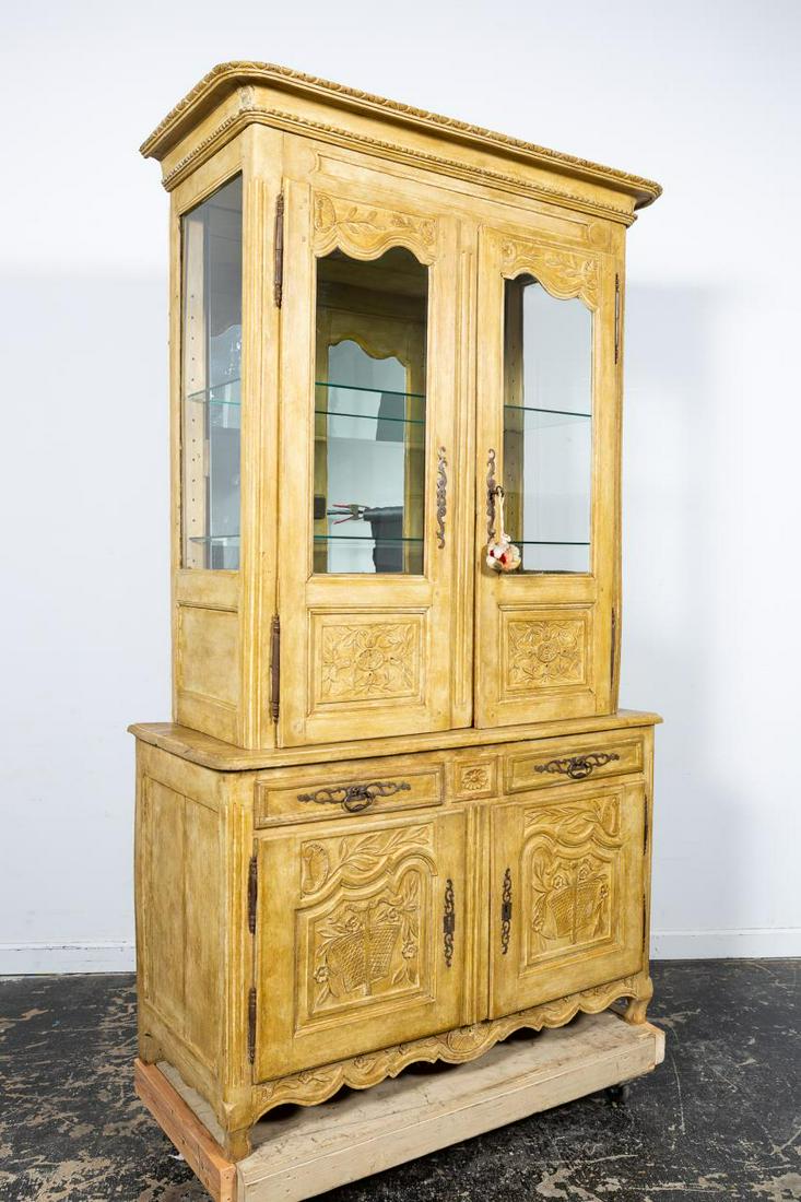 19TH C. FRENCH PROVINCIAL GLASS FRONT BUFFET: French, 19th century. Provincial oak buffet deux corps in the Louis XV taste, having a shaped carved cornice, double doors with later glazed upper panels, the interior fitted with shelves, lower case 