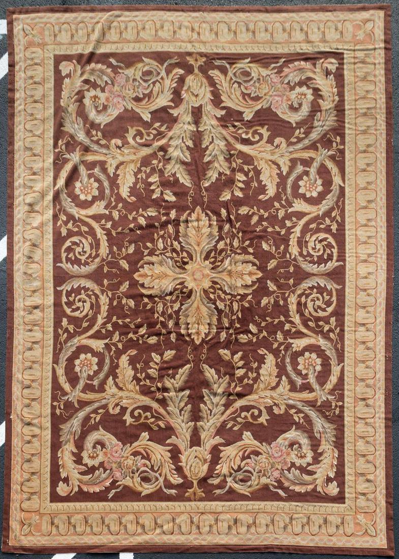 20TH C. HAND-KNOTTED FRENCH AUBUSSON RUG OR CARPET: Possibly French, 20th century. Hand-knotted Aubusson rug or carpet, having a brown field with center medallion, symmetrical floral design with swags and scrolls and corresponding design border. Unmark