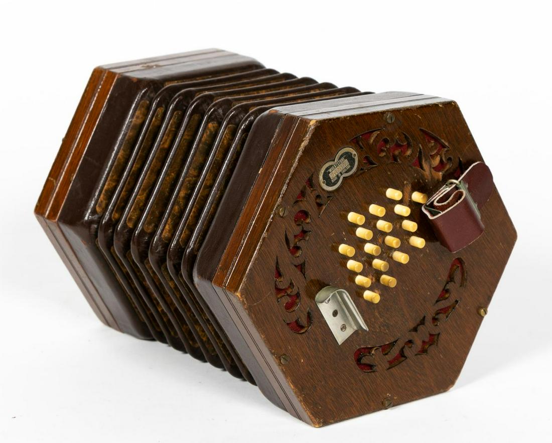 MID-CENTURY, C. WHEATSTONE CASED MAPLE CONCERTINA: Charles Wheatstone & Co. (British, 1829-1960s). A thirty-six key maple concertina with fretted hexagonal endplates and a six fold brown leather bellows. Marked with serial number "36317" and "Wheatsto