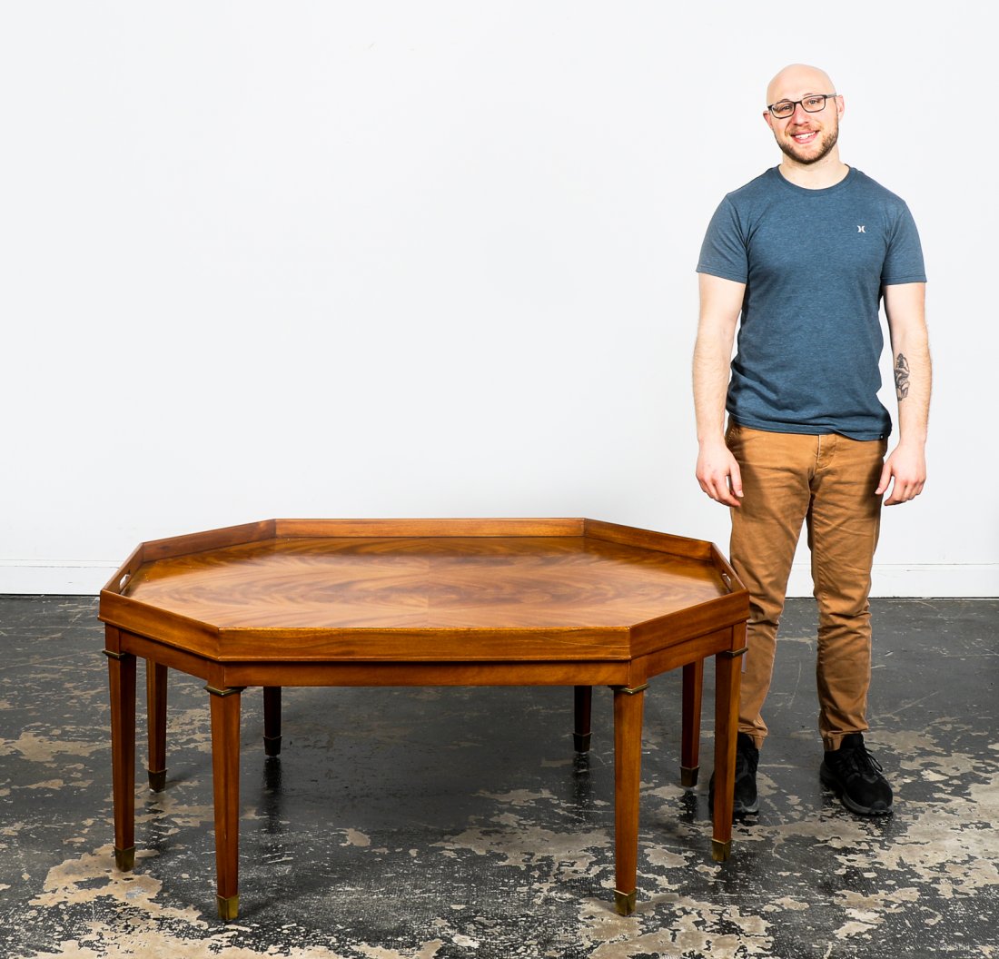 HENREDON RALPH LAUREN OCTAGONAL COCKTAIL TABLE: Henredon (American, founded 1945), Ralph Lauren Home (American, founded 1967), late 20th century. Oversized octagonal form flame mahogany cocktail or coffee table having a faux tray top and rising on 