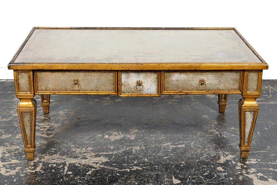 ITALIAN STYLE GILTWOOD MIRRORED COCKTAIL TABLE: Likely Southeast Asian, late 20th century. Contemporary cocktail or coffee table in the mid-century Italian-neoclassical taste having applied distressed and smoked mirror, three drawers and two slides