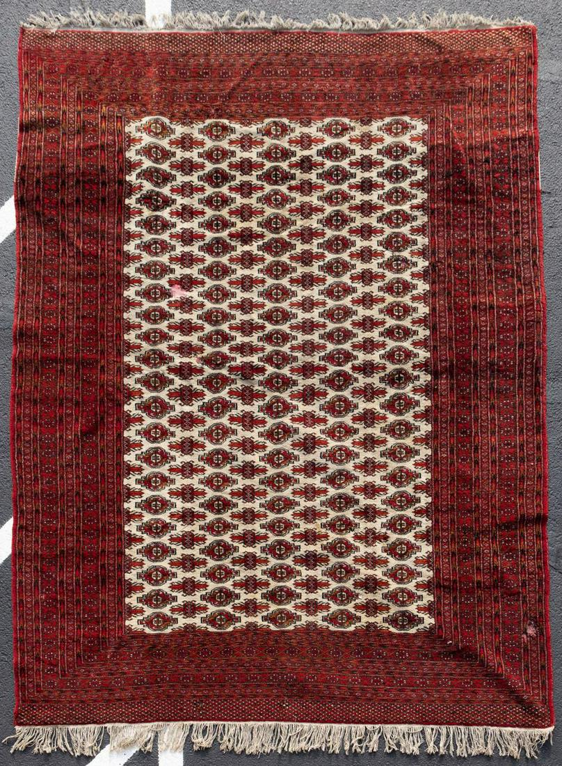 PAKISTANI HANDWOVEN BOKHARA RUG, 20TH CENTURY: Likely Pakistani, 20th century. Handwoven wool Bokhara patterned rug having a red border containing a cream field. Unmarked. Approx. 6'7.5" x 8'8.25".
