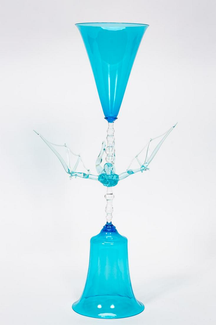 LUCIO BUBACCO "IKARUS" ART GLASS CHALICE SCULPTURE: Lucio Bubacco (Italian, born 1957), 1999. A large double sided Murano erotic art glass chalice featuring a winged male nude stem with a double sided aquamarine chalice or goblet. Signed "Lucio Bubacco