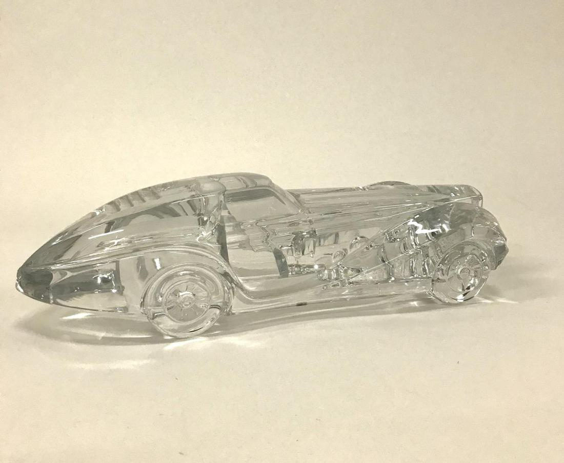 DAUM "COUPE RIVIERA" CRYSTAL CAR MASCOT SCULPTURE: Daum (French (Nancy), founded 1878). A glass sculpture of a "Coupe Riviera". Marked "Daum Nancy" to side and with original sticker label to front grill. Approx: h. 4.25", w. 6.5", d. 15.5".