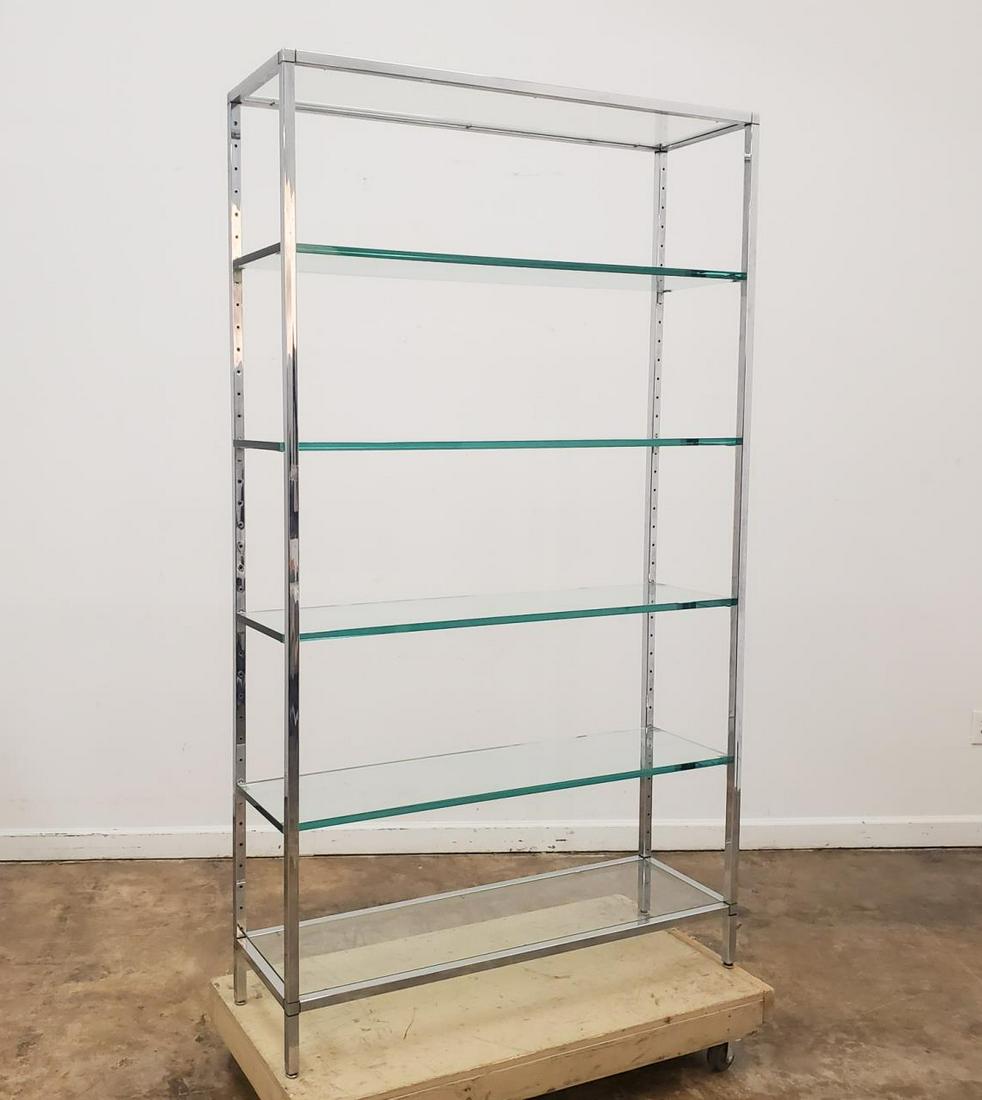 MILO BAUGHMAN STYLE CHROME AND GLASS ETAGERE: American, third quarter 20th century. Mid Century Modern etagere in the style of Milo Baughman, having a square chrome plated frame and multiple glass shelves. Unmarked. Approx. h. 84", w. 48", d. 14.