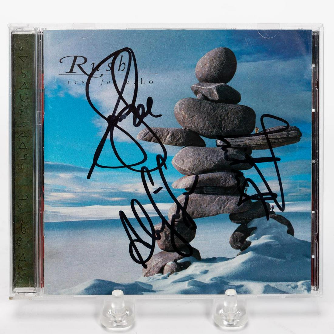 RUSH, "TEST FOR ECHO" AUTOGRAPHED COMPACT DISC: Rush (Canadian, formed 1968). A "Test For Echo" CD signed by Geddy Lee, Alex Lifeson and Neil Peart. . Approx: 5" x 5.5".