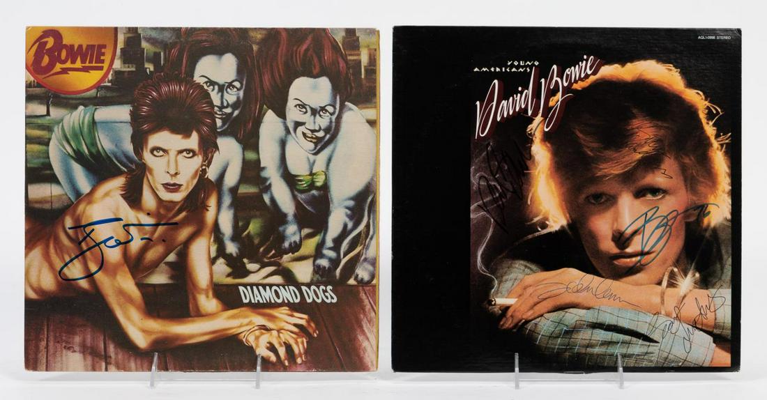 DAVID BOWIE AUTOGRAPHED RECORDS, "YOUNG AMERICANS": David Bowie (British, 1947-2016). Two albums or LPs "Young Americans" and "Diamond Dogs" signed by David Bowie. Approx: 12.25" x 12.25". Note: The John Lennon signature has not been authenticated.