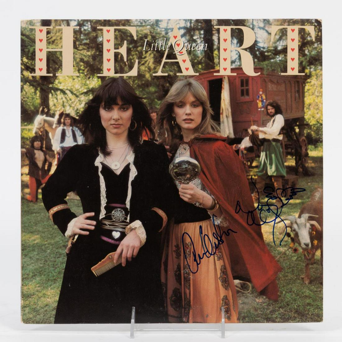 HEART AUTOGRAPHED, "LITTLE QUEEN" RECORD ALBUM: Heart (American, formed 1970). One record or LP "Little Queen" signed by the original band members Ann Wilson and Nancy Wilson. Approx: 12.25" x 12.25".
