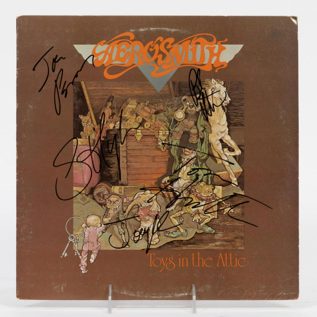 AEROSMITH SIGNED "TOYS IN THE ATTIC" RECORD ALBUM: Aerosmith (American, formed 1970). A record or LP "Toys in the Attic" autographed by Steven Tyler, Joe Perry, Joey Kramer, Brad Whitford, and Tom Hamilton. Approx: 12.25" x 12.25".